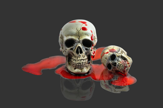 Still Life Human Skull with red blood on gray background. Skeleton and Skulls for HALLOWEEN FESTIVAL.