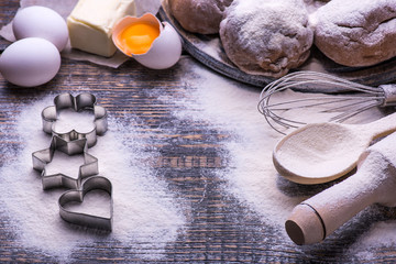 Ingredients for baking cookies, biscuits, flour, eggs, butter, baking dish in the form of heart on...
