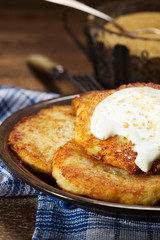 Homemade potato pancakes served with sour cream and brown sugar