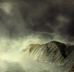 Landscape.  Mountains and sea in mist