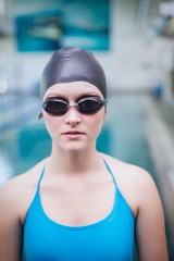 Fototapeta na wymiar Pretty woman wearing swim cap and swimming goggles
