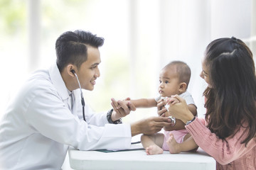 baby being checked by a doctor