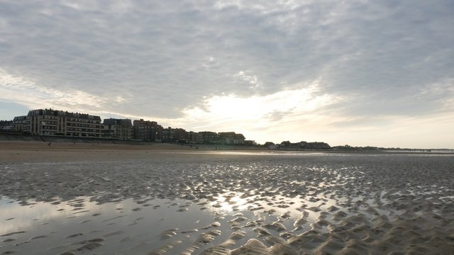 Sunset over Cabourg city on the Le Mans channel close-up 4K 2160p 30fps UltraHD footage - Sunlight over beach on northern France Normandy style buildings 4K 3840X2160 UHD video 