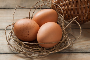 three eggs in a nest of thread