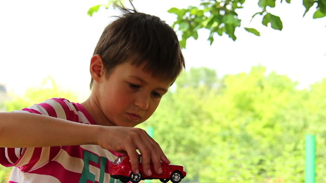 boy dreams of a car, boy playing with a toy car, Land Cruiser