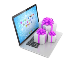 Gift box with ribbon bow on laptop keyboard