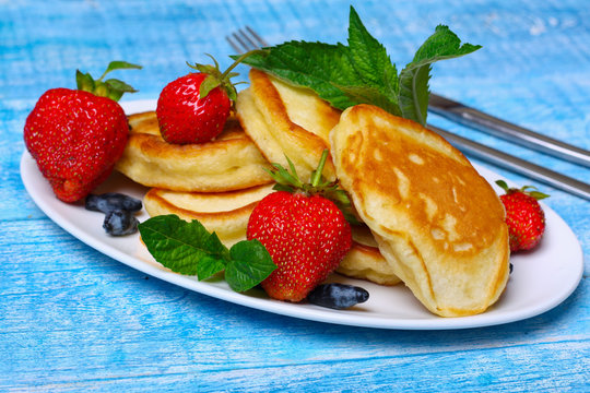 Plate of delicious freshly prepared pancakes with strawberry
