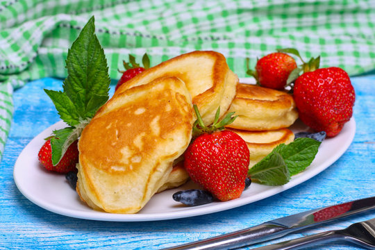 Plate of delicious freshly prepared pancakes with strawberry