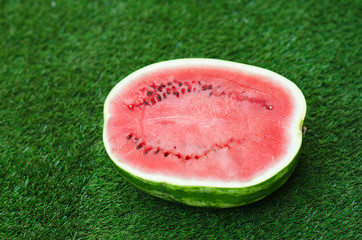 Summer and fresh watermelon theme: beautiful ripe watermelon lying on green grass