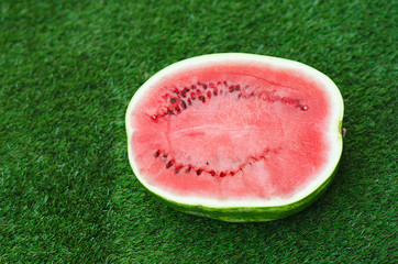 Summer and fresh watermelon theme: beautiful ripe watermelon lying on green grass