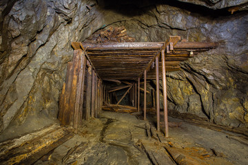 Fototapeta na wymiar underground abandoned iron mine ore tunnel with rails Ural