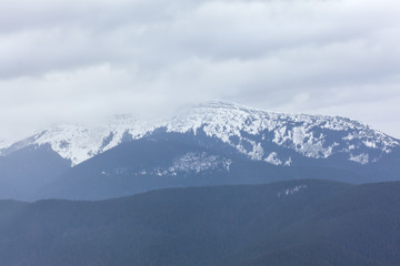 snowy peak in the clouds