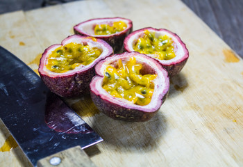 Passion fruit on chopping block with knife