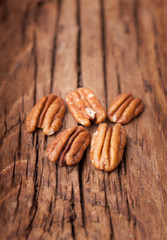 Pecan nuts on old wooden background