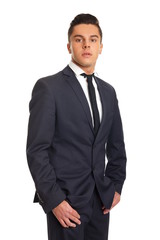 Young businessman in suit standing on white background