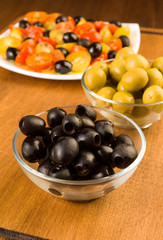 green and black olives in glass bowl