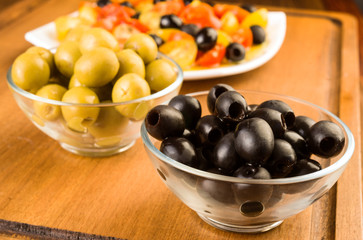 green and black olives in glass bowl