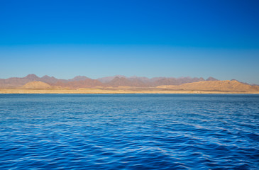 View on red mountains from the sea