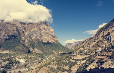 Wide mountain valley with river flowing through.