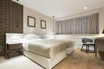 Modern double bed hotel bedroom interior