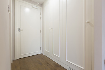 Interior of a white hotel corridor with closet