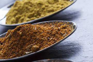 oriental indian spices curry paprika nutmeg on slate