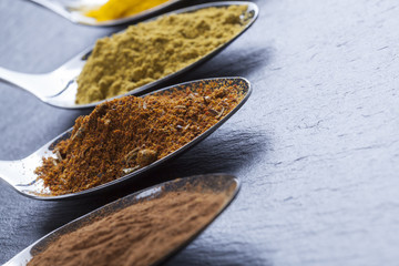 oriental indian spices curry paprika nutmeg on slate
