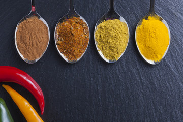 oriental indian spices curry paprika nutmeg on slate