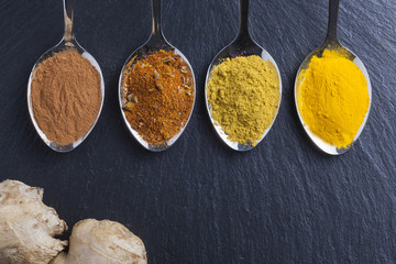 oriental indian spices curry paprika nutmeg on slate