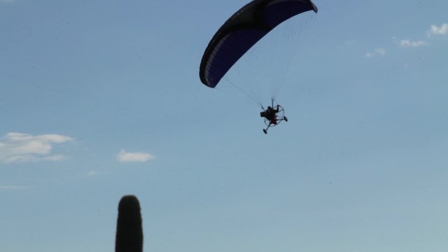 Paraplane flying over the desert