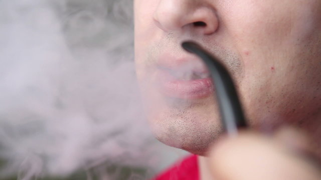 man smoking a pipe closeup