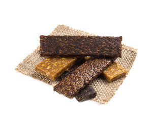 Fruit and linen bars lie on each other on a piece of burlap isolated