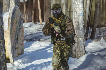 A man with a paintball marker is played on the field