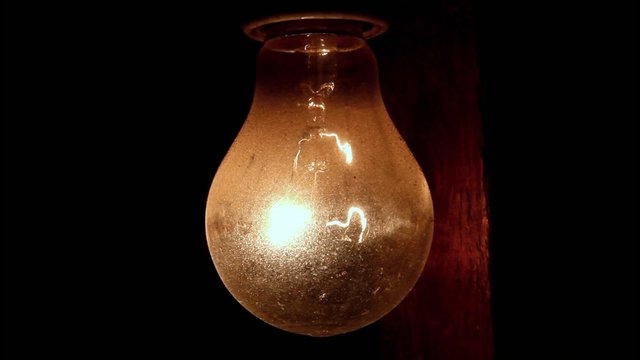 turn on and off light bulb hanging on a wooden beam