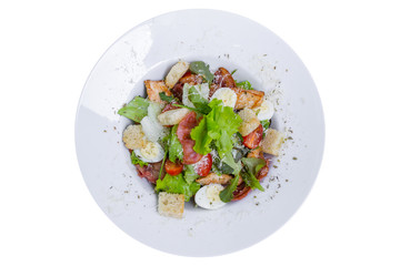 Caesar salad with chicken and quail eggs, isolated