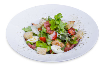 Caesar salad with chicken and quail eggs, isolated