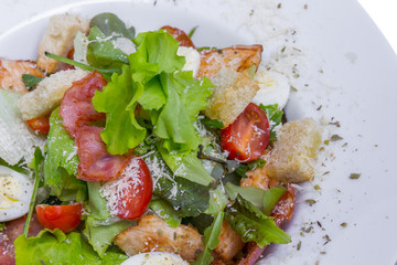 Caesar salad with chicken and quail eggs