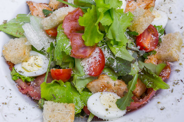 Caesar salad with chicken and quail eggs