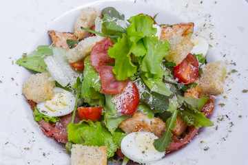 Caesar salad with chicken and quail eggs
