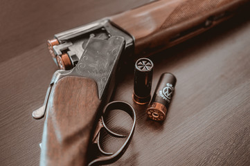 Hunting rifle on a wooden background