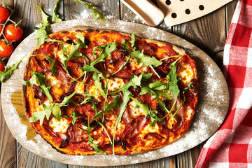 Home made pizza on wooden table