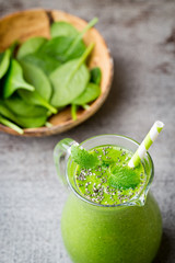 Spinach smoothie, on the grey  background.