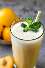 Plum smoothie, on the grey  background.