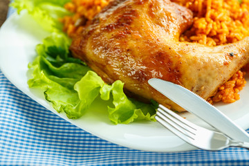 Delicious dish of chicken thigh with rice and salad leaves