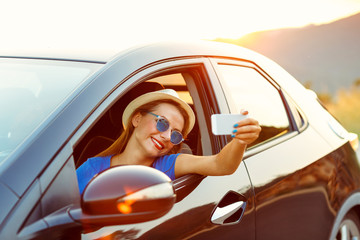 Woman in hat and sunglasses making self portrait sitting in the