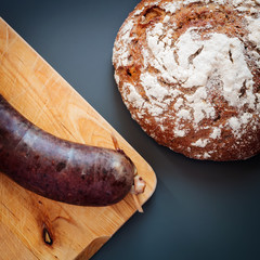 Fresh blood sausage and bread on a table
