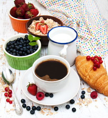 Fresh berries, coffee and croissant