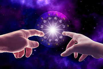 hands touching astrology chart with all zodiac signs