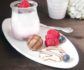 Sweet breakfast, yoghurt with wild berries and chocolate cookies