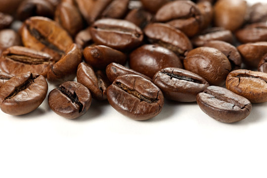Roasted coffee beans on white background